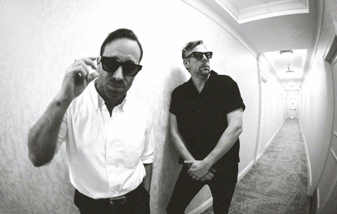 Team members of The Black Keys posing on a hallway