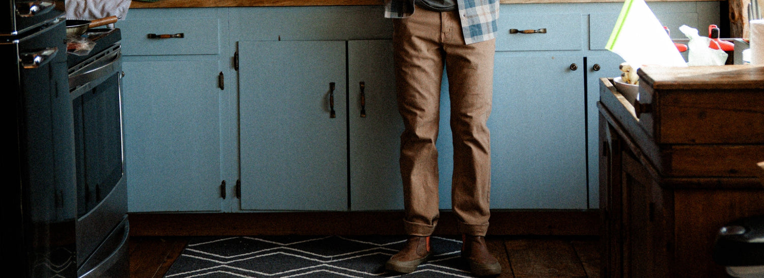 Someone crossing rocks and water in bedrock pant